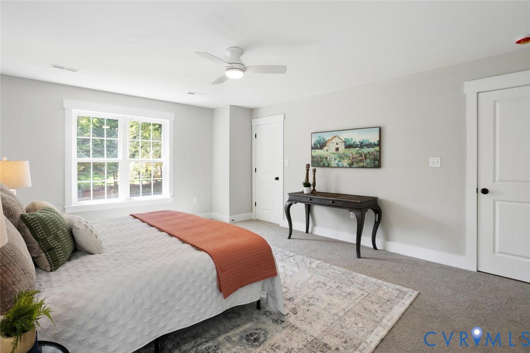 13800 Summerlook Lane Chesterfield, VA 23832 - Photo 32 of 49 a bedroom with a bed a table and painting