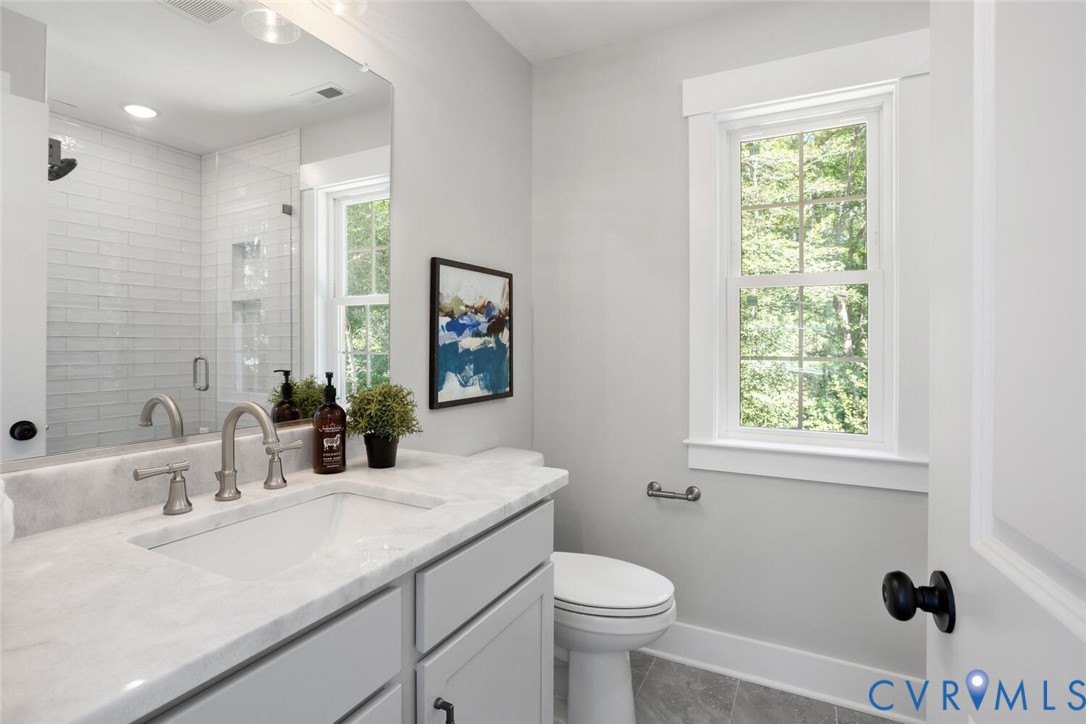 13800 Summerlook Lane Chesterfield, VA 23832 - Photo 34 of 49 a bathroom with a sink toilet a mirror and shower