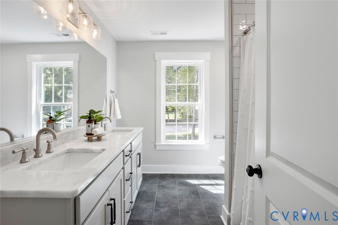 13800 Summerlook Lane Chesterfield, VA 23832 - Photo 38 of 49 a bathroom with a double vanity sink a mirror and a shower