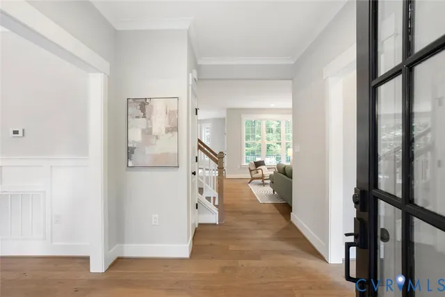 a view of a hallway with living room and furniture