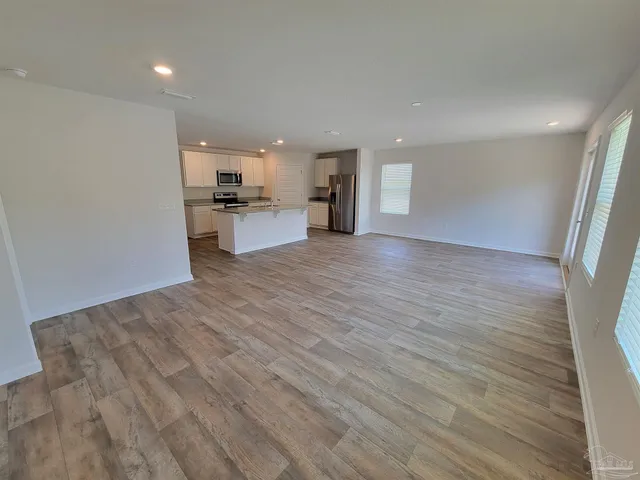 a view of kitchen with kitchen island and wooden floor