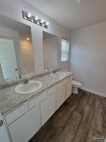 a bathroom with a double vanity sink and a mirror