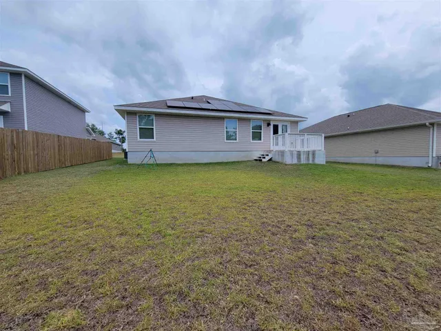 a view of a house with a yard and sitting area