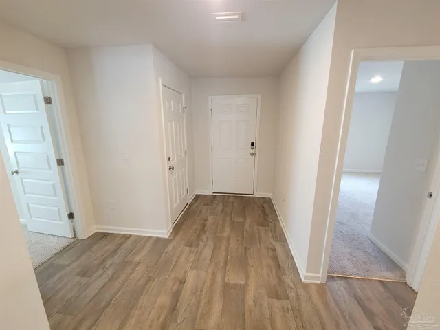 wooden floor in an empty room with a mirror
