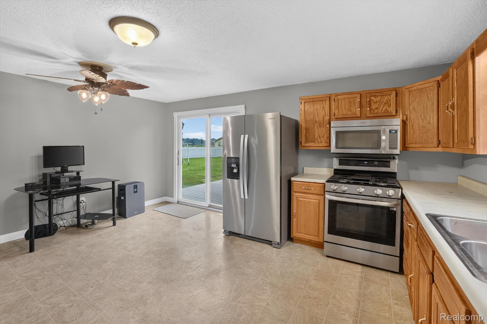 10977 Maple Road Birch Run, MI 48415 - Photo 12 of 49 Kitchen featuring wood cabinetry, stainless steel appliances, and neutral countertops