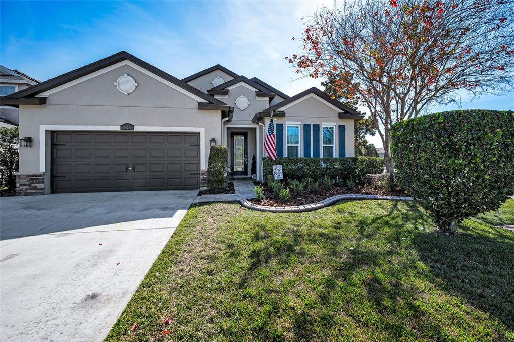 a front view of a house with a yard and garage