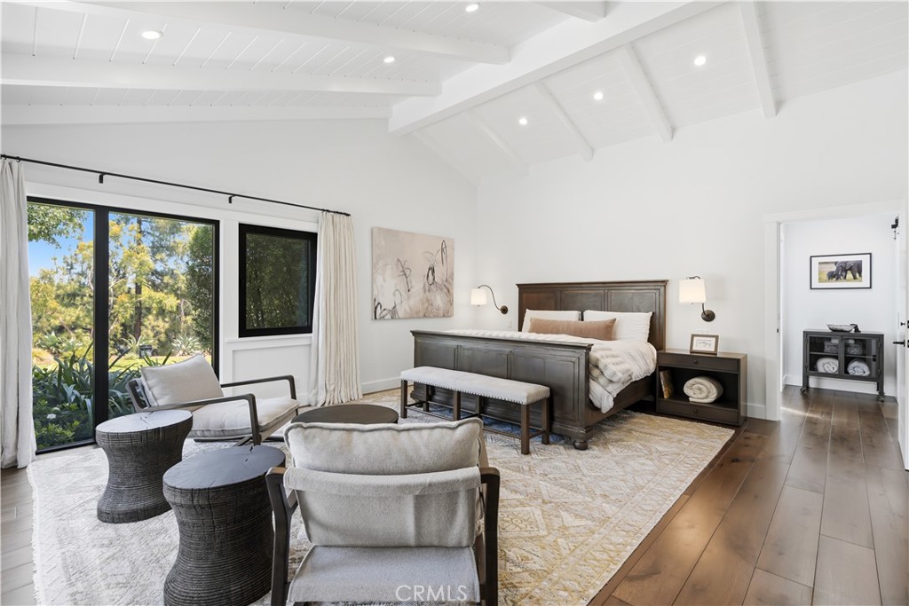 24884 Jim Bridger Road Hidden Hills, CA 91302 - Photo 16 of 31 a bedroom with furniture and a large window