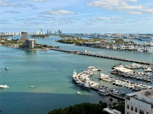 a view of a room with wooden floor and large windows