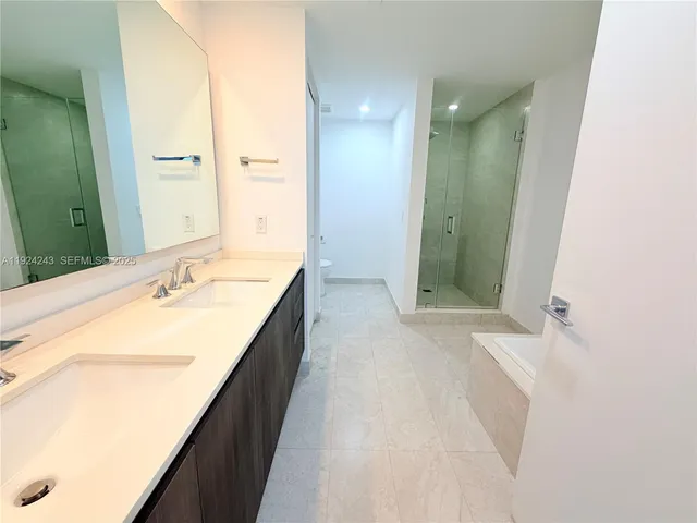 a view of a livingroom with furniture and floor to ceiling window