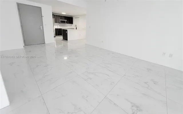 a kitchen with stainless steel appliances a refrigerator sink and microwave