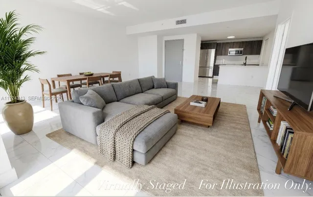 a kitchen with stainless steel appliances a refrigerator sink and microwave