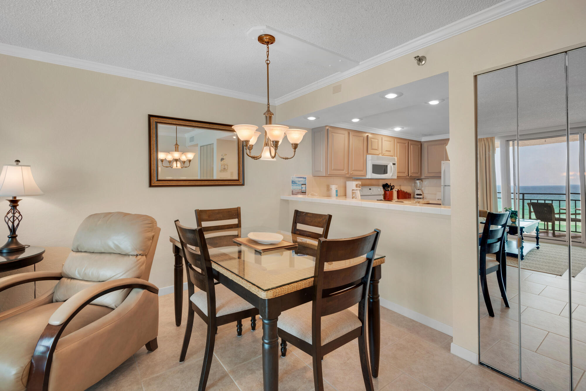 381 Santa Rosa Boulevard, Unit C611 Fort Walton Beach, FL 32548 - Photo 4 of 12 a dining room with stainless steel appliances kitchen island granite countertop a table chairs and a refrigerator