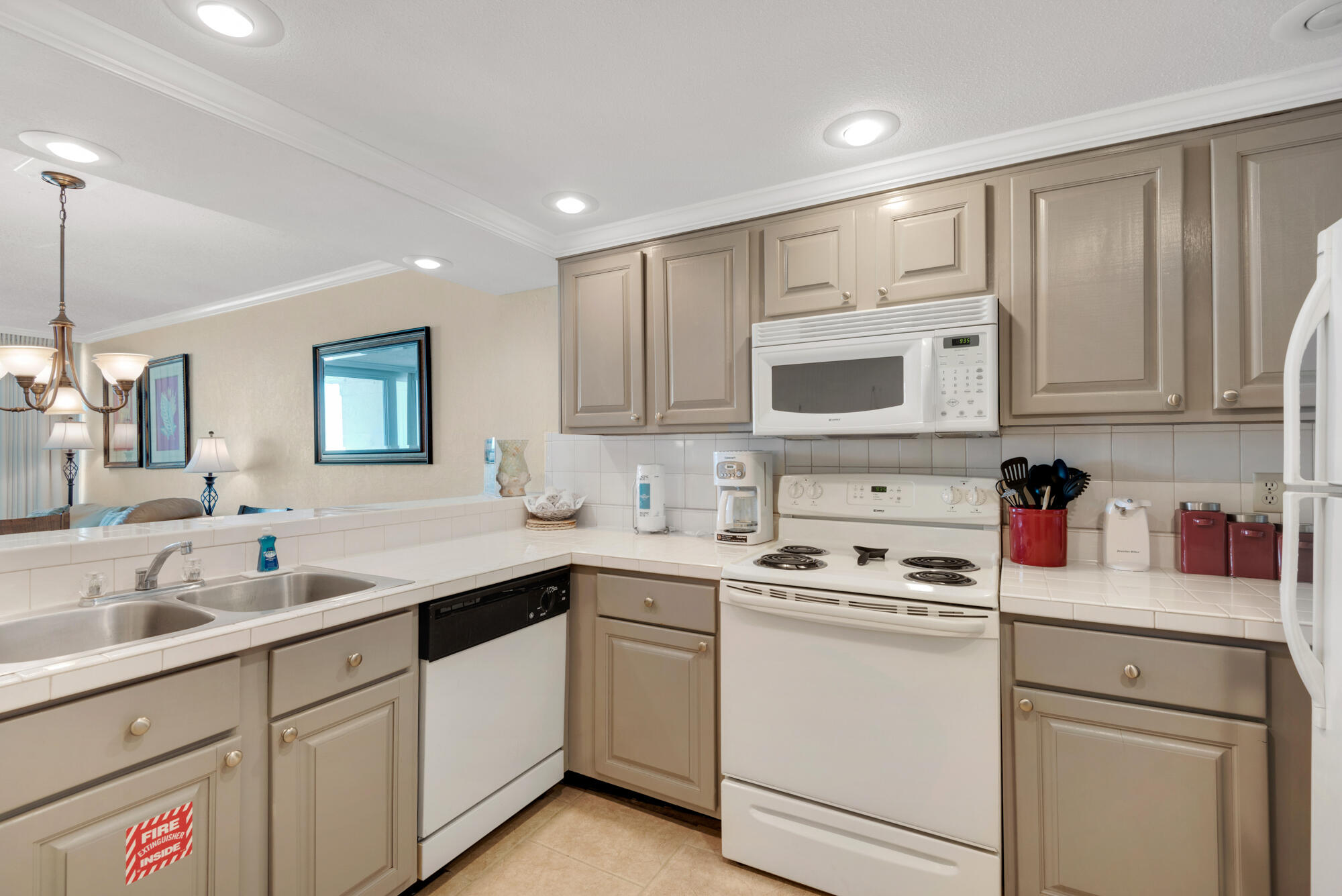 381 Santa Rosa Boulevard, Unit C611 Fort Walton Beach, FL 32548 - Photo 5 of 12 a kitchen with cabinets appliances a sink and a counter top space