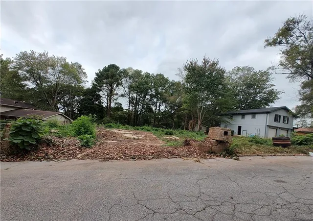 a backyard of a house with basket ball court and trampoline