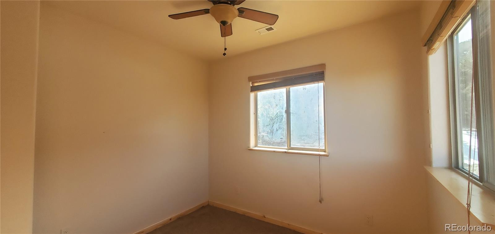 4984 Edmond Road Fort Garland, CO 81133 - Photo 16 of 24 an empty room with windows and fan