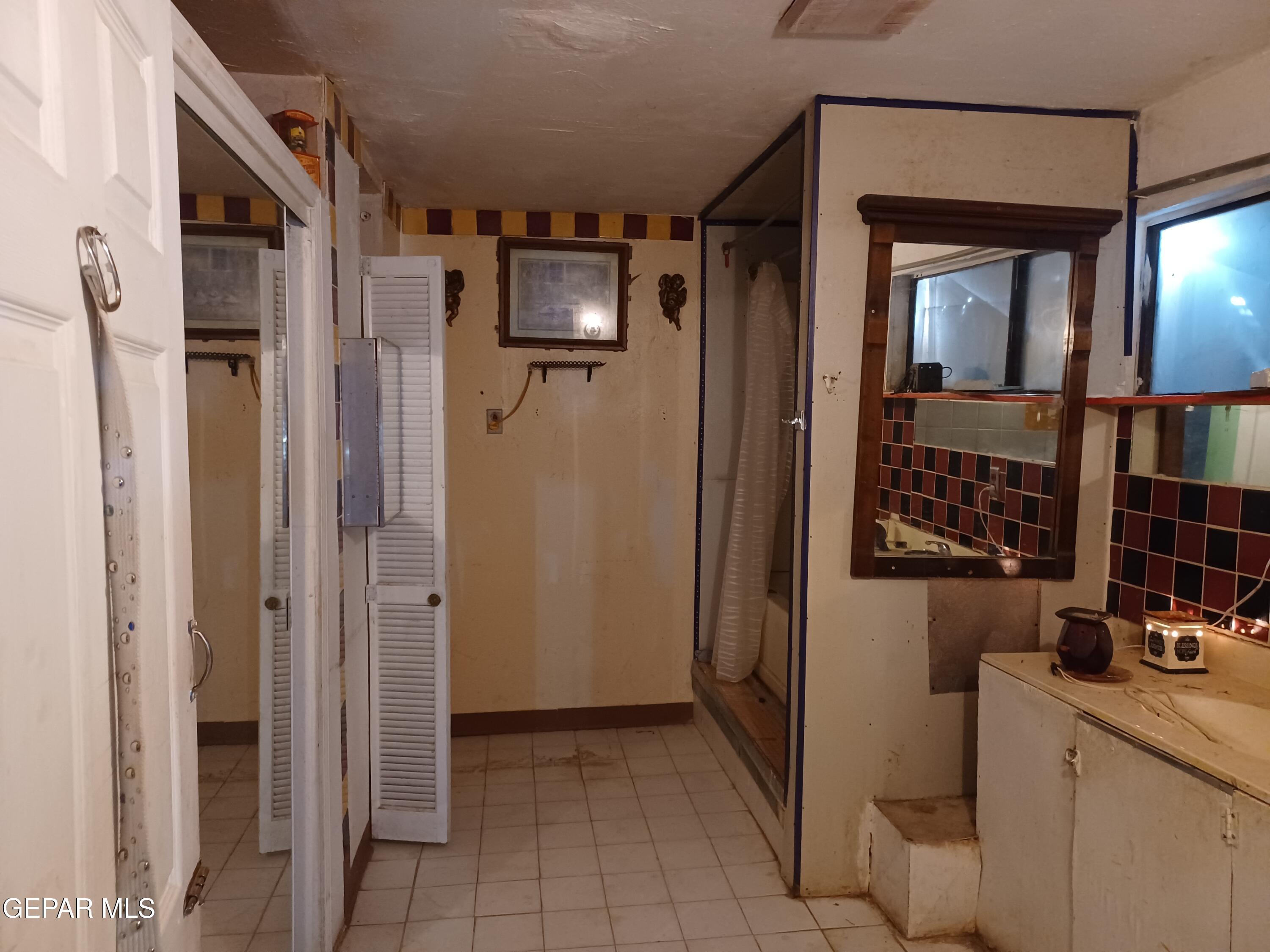 627 Milo Drive El Paso, TX 79927 - Photo 13 of 21 a view of hallway with chandelier and refrigerator