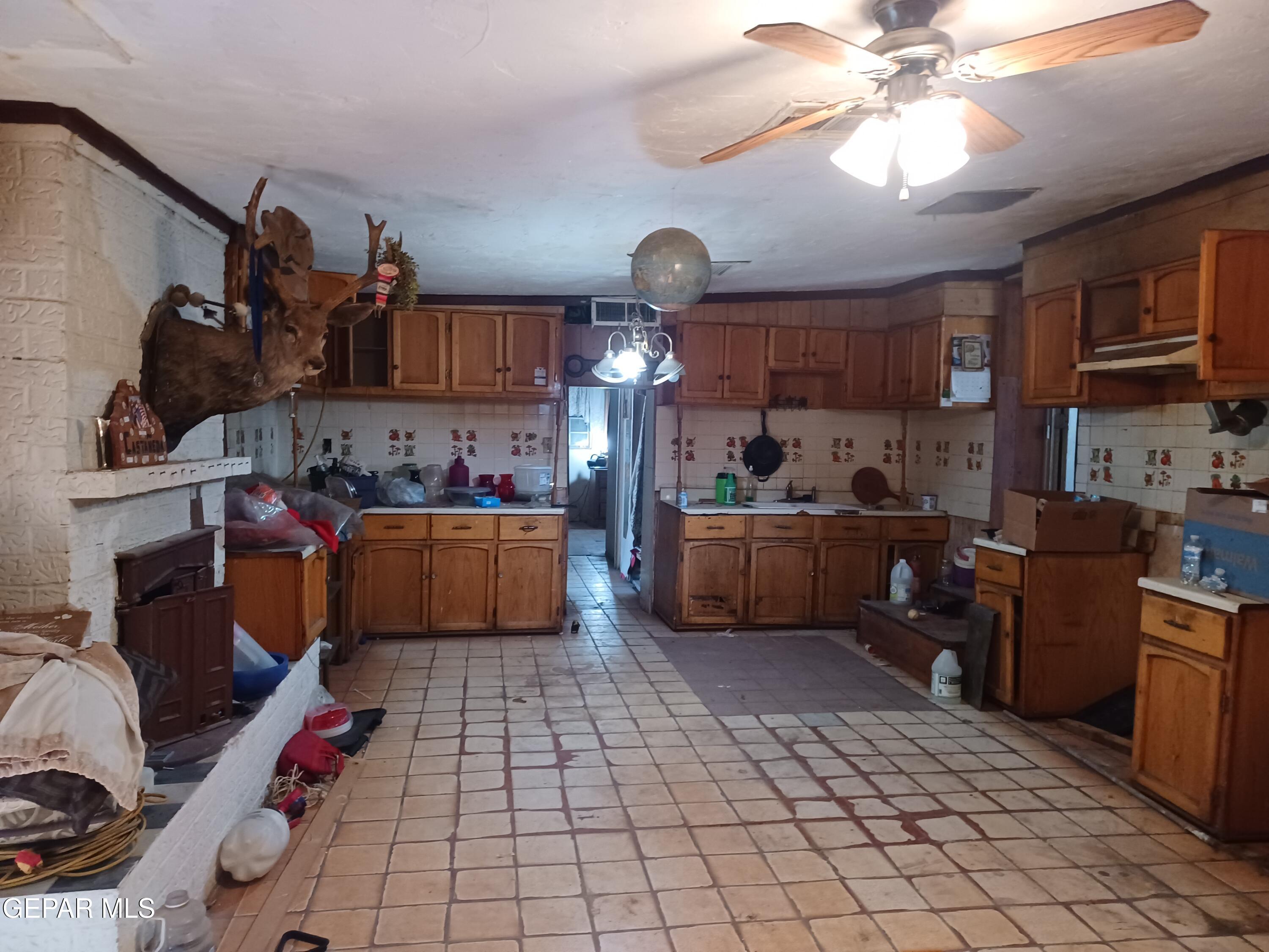 627 Milo Drive El Paso, TX 79927 - Photo 5 of 21 a kitchen with a cabinets a sink and a stove