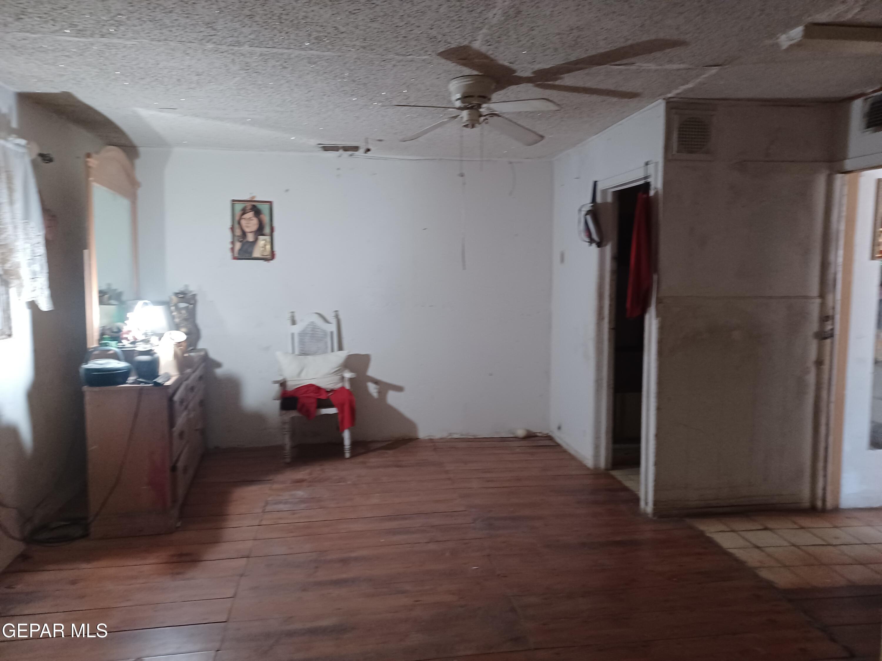 627 Milo Drive El Paso, TX 79927 - Photo 7 of 21 a bedroom with a bed and a chandelier