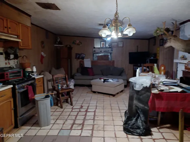 a kitchen with kitchen island granite countertop a stove and a dining table