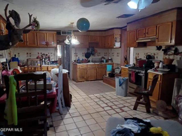 a kitchen with lots of counter top space appliances and cabinets