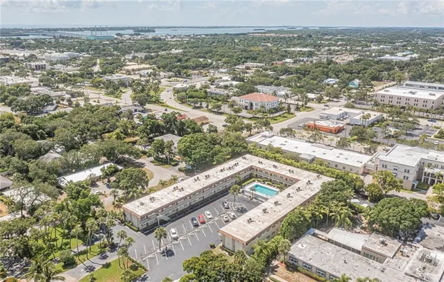 an aerial view of a residential houses with city view