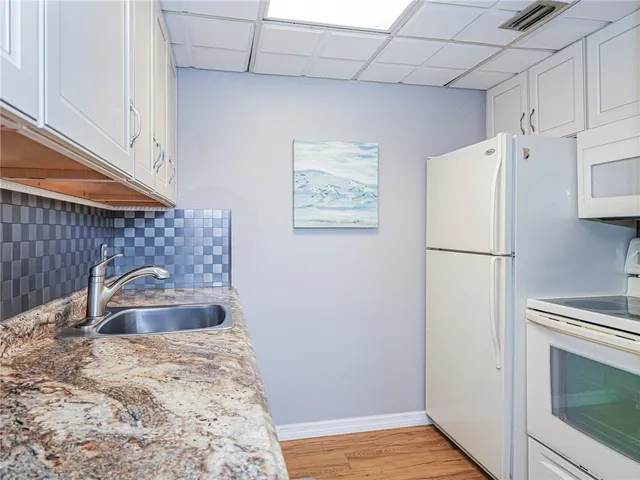 a bathroom with a sink and a refrigerator