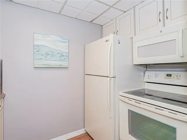 a white refrigerator freezer sitting inside of a kitchen