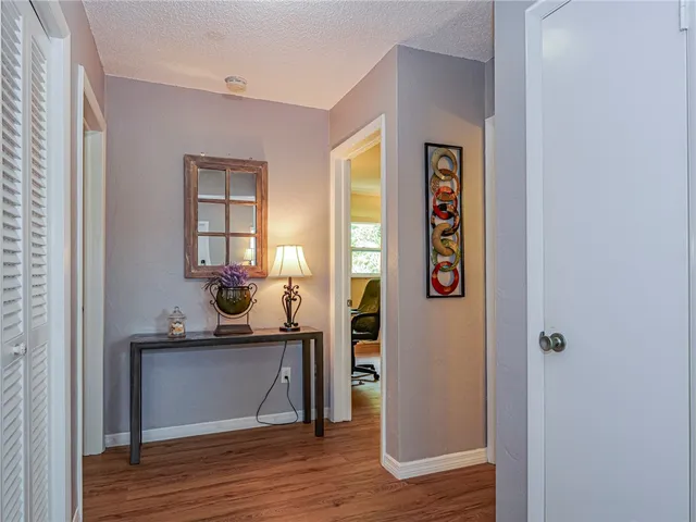 a view of kitchen with wooden floor and cabinets