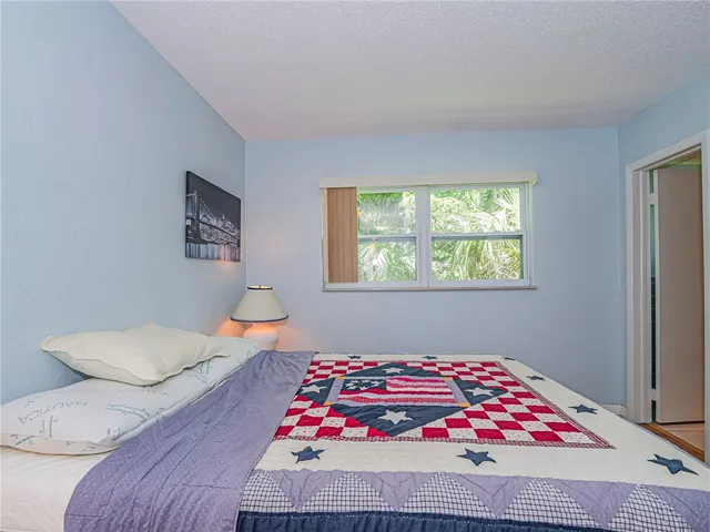 a bedroom with a bed and a lamp