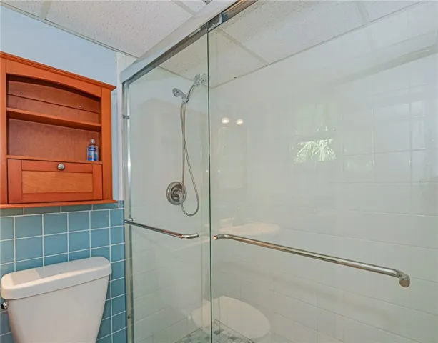 a bathroom with a shower a toilet and a sink