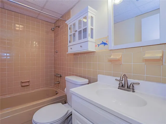 a bathroom with a sink a toilet and bathtub