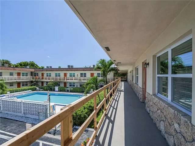 a view of a balcony with wooden floor and fence