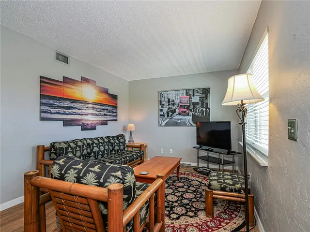 a bedroom with furniture and a flat screen tv
