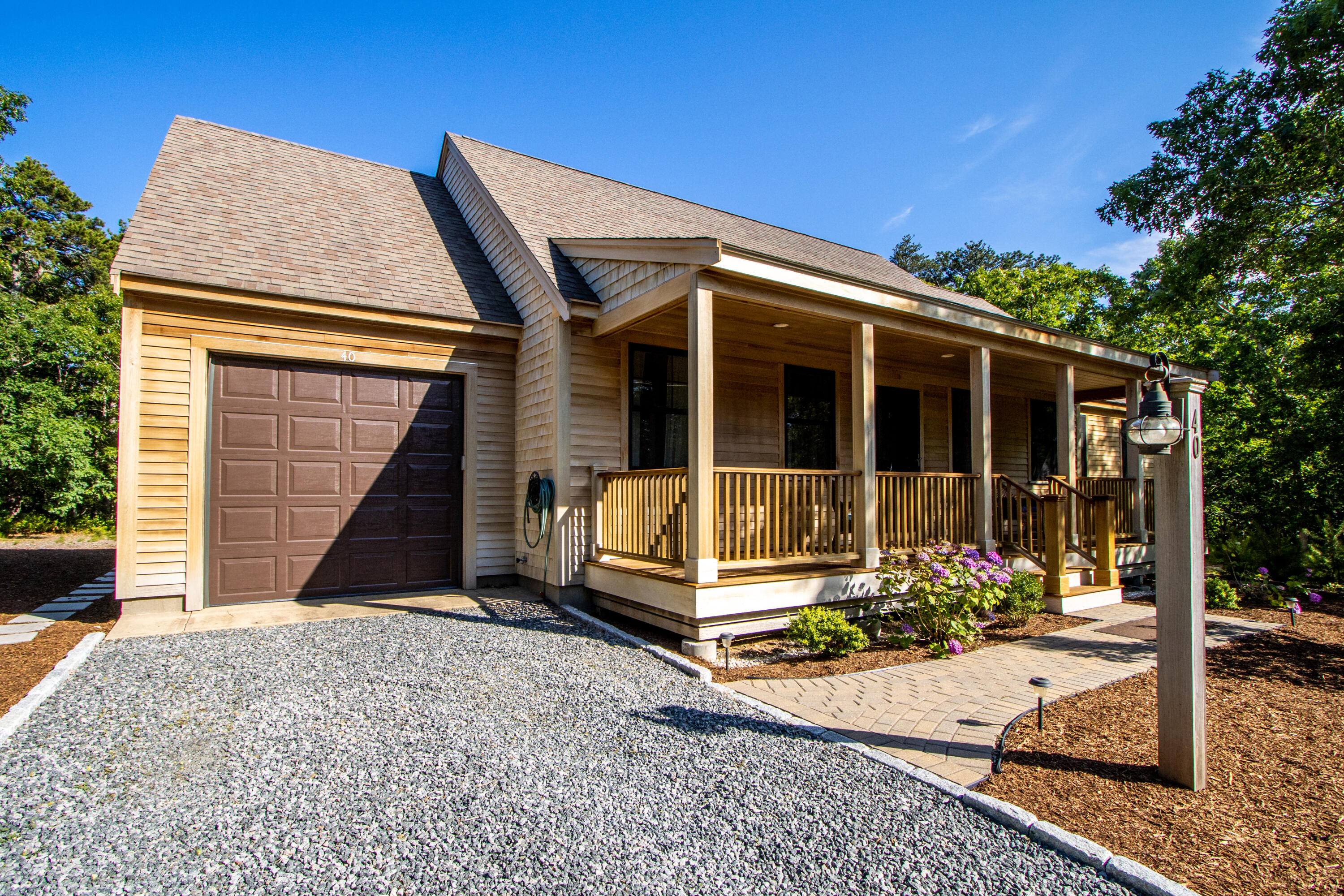 40 Pine Needle Road Wellfleet, MA 02667 - Photo 1 of 36 a view of a house with a small yard and plants