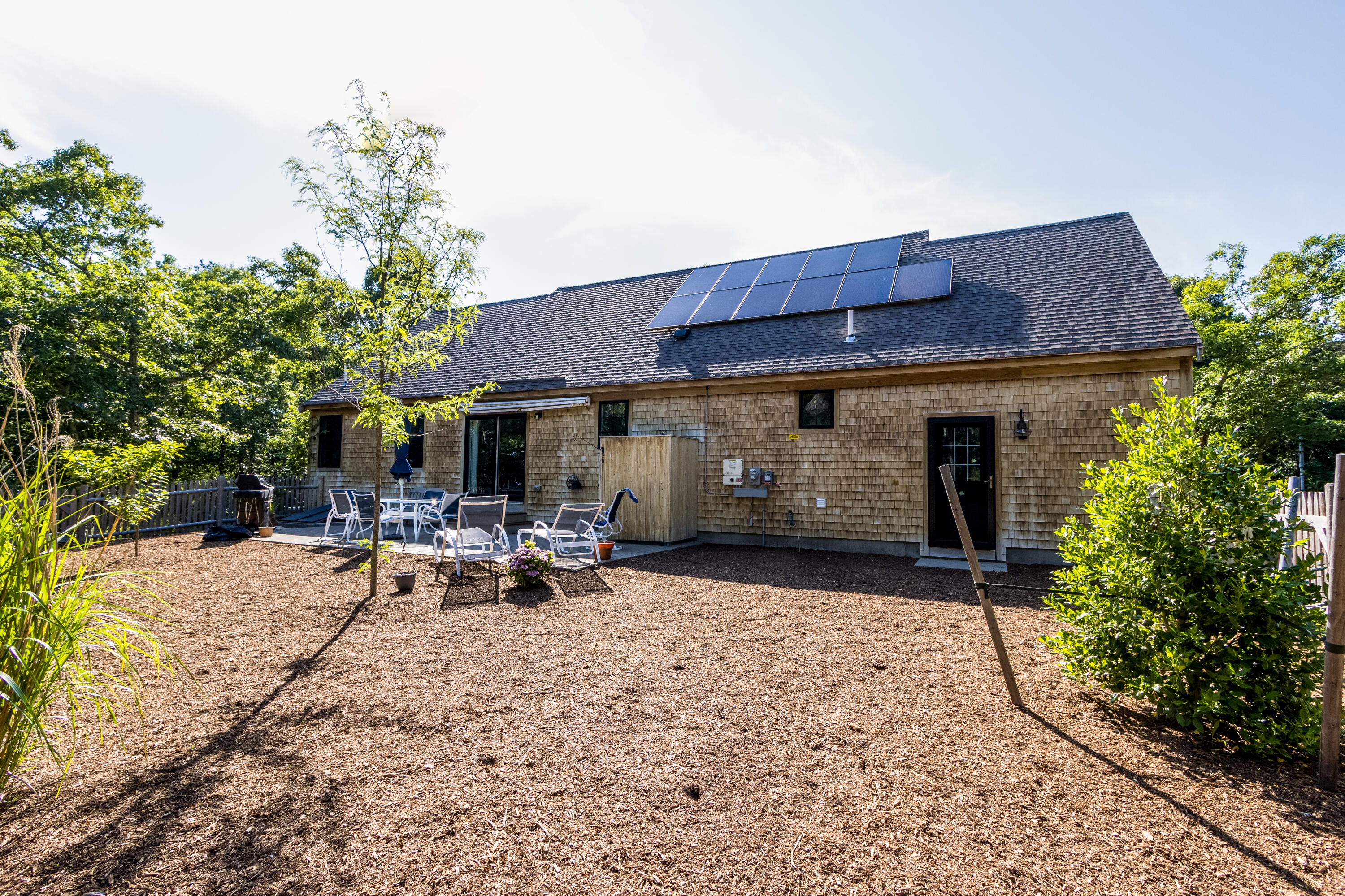 40 Pine Needle Road Wellfleet, MA 02667 - Photo 12 of 36 a view of a house with backyard sitting area and garden