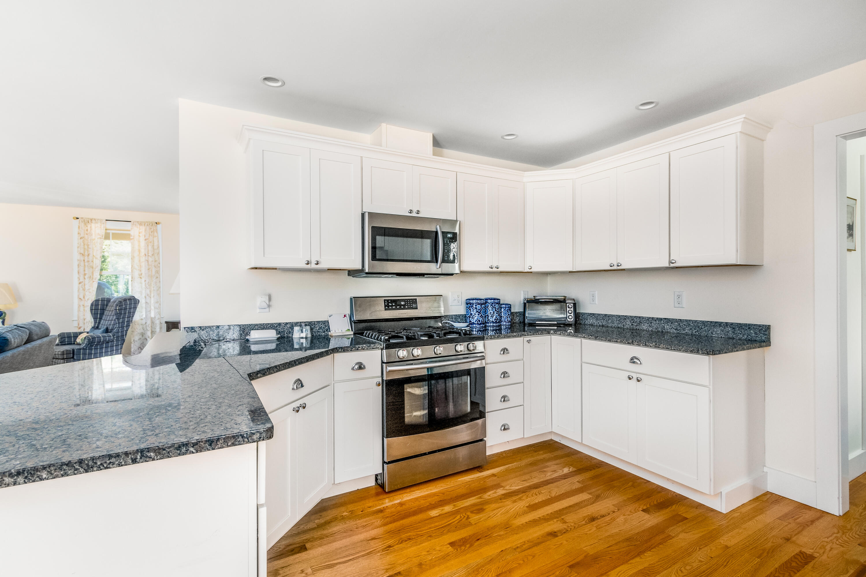 40 Pine Needle Road Wellfleet, MA 02667 - Photo 16 of 36 a kitchen with granite countertop a sink stainless steel appliances and white cabinets