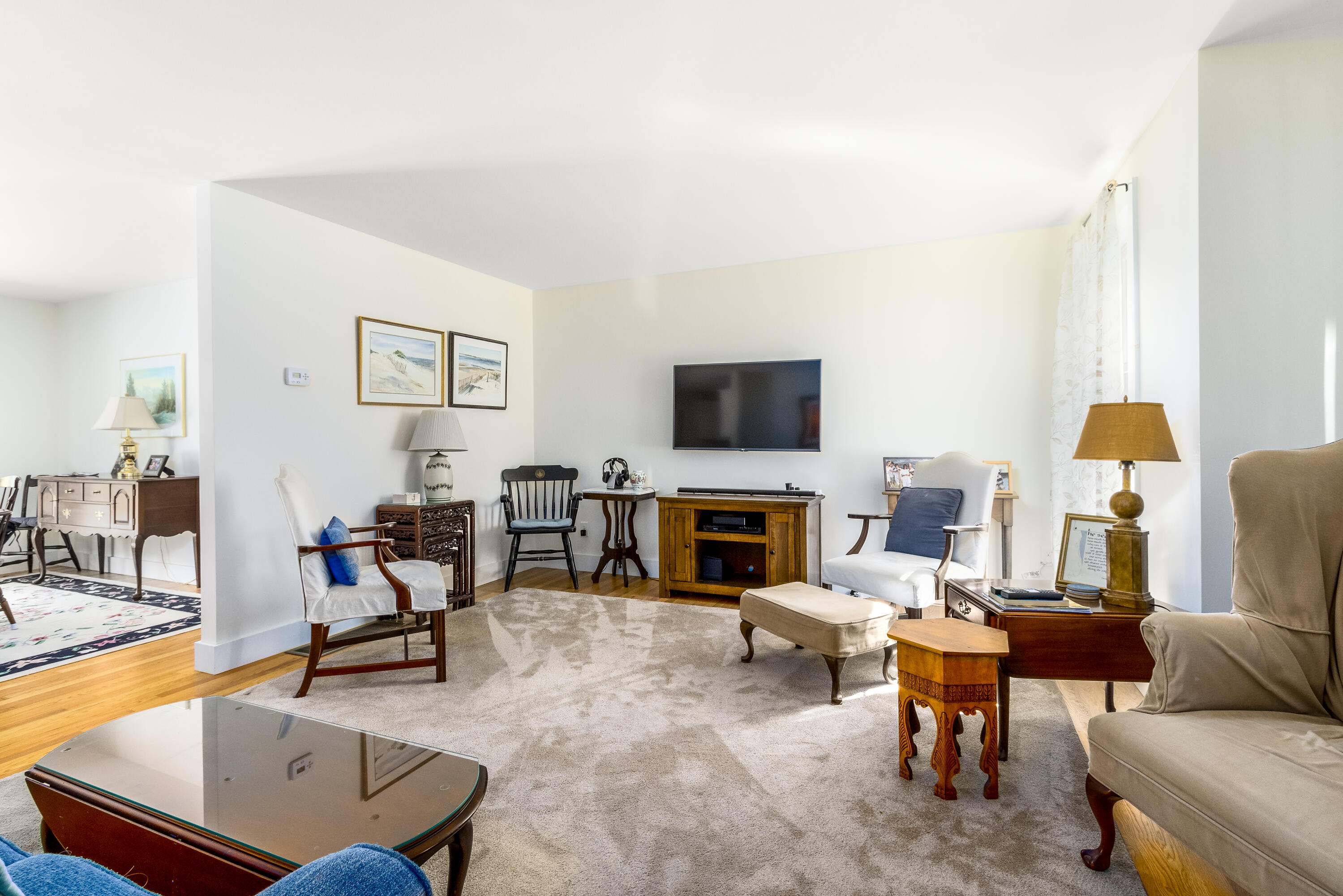 40 Pine Needle Road Wellfleet, MA 02667 - Photo 17 of 36 a living room with furniture a dining table and a fireplace
