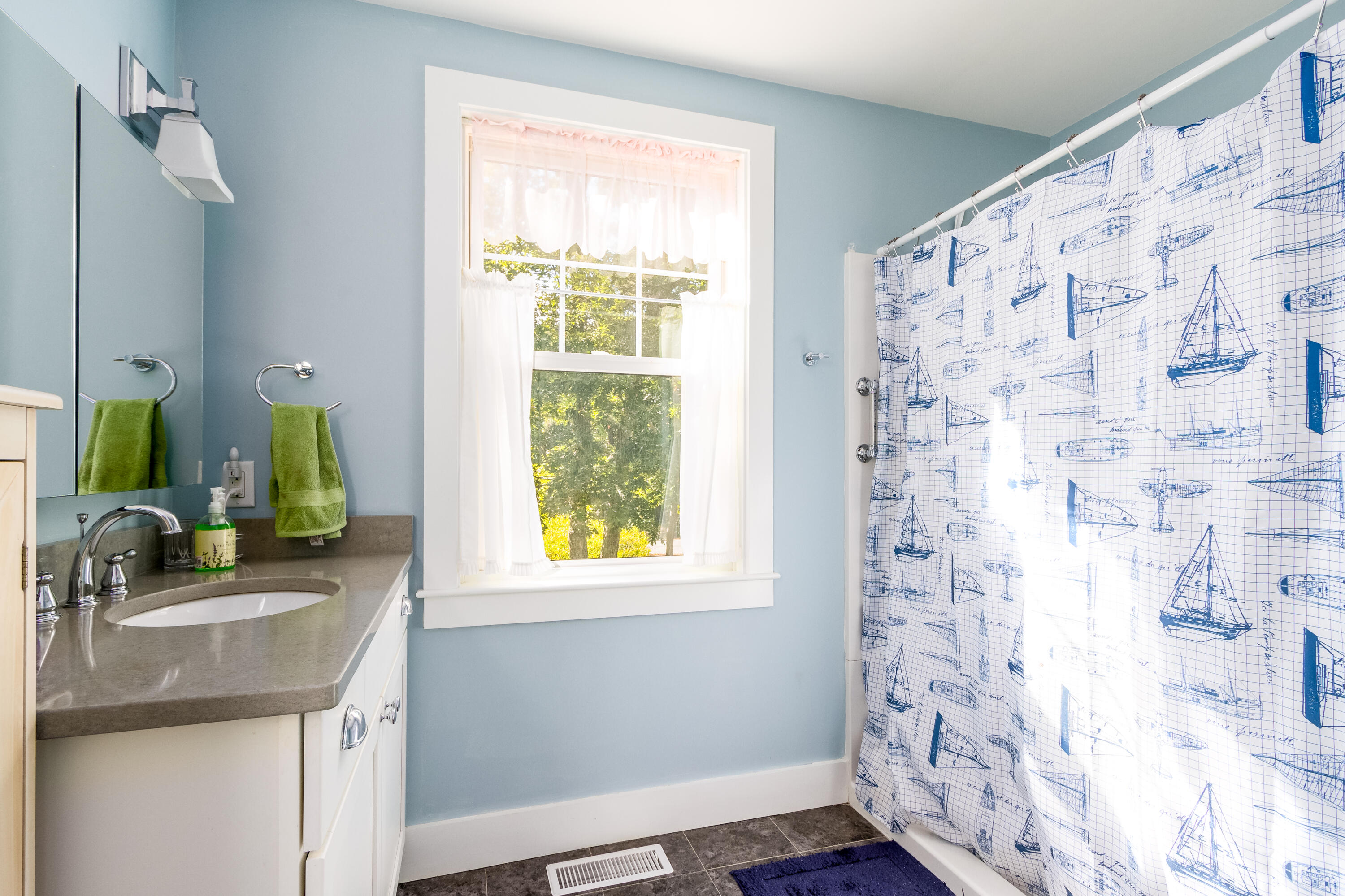 40 Pine Needle Road Wellfleet, MA 02667 - Photo 32 of 36 a bathroom with a granite countertop sink a mirror and a shower