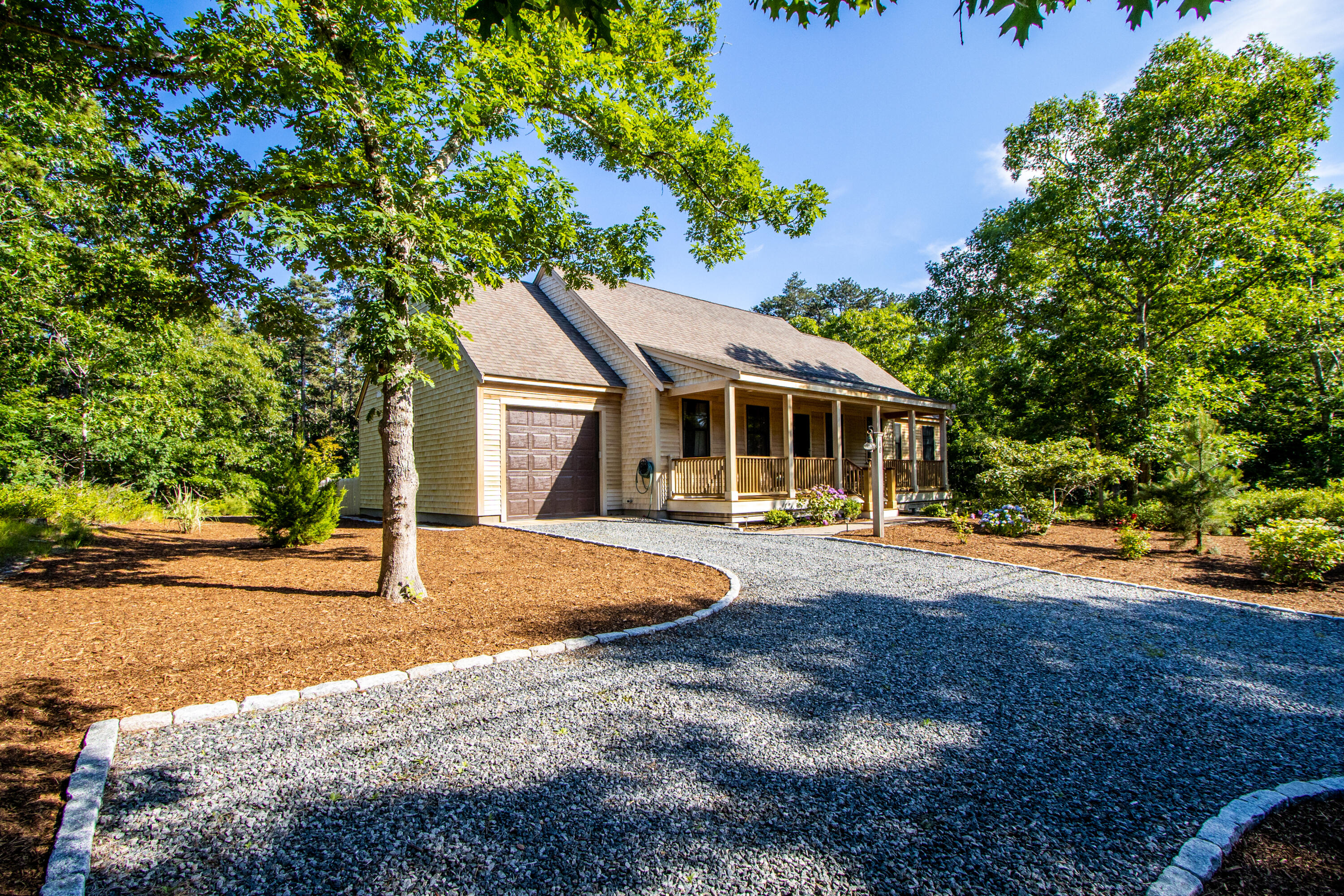 40 Pine Needle Road Wellfleet, MA 02667 - Photo 4 of 36 a front view of a house with porch yard and outdoor seating