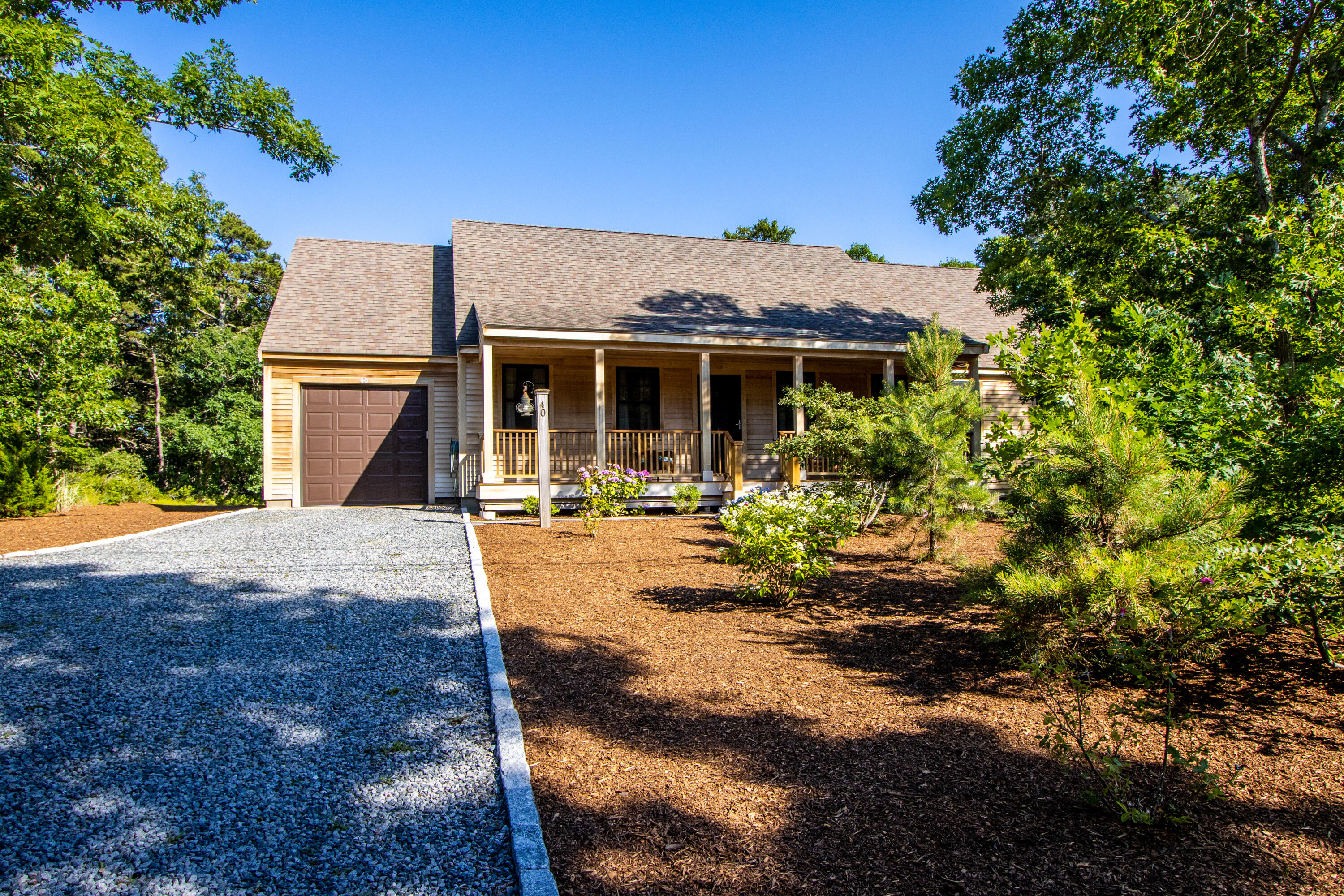 40 Pine Needle Road Wellfleet, MA 02667 - Photo 6 of 36 a front view of a house with yard porch and furniture