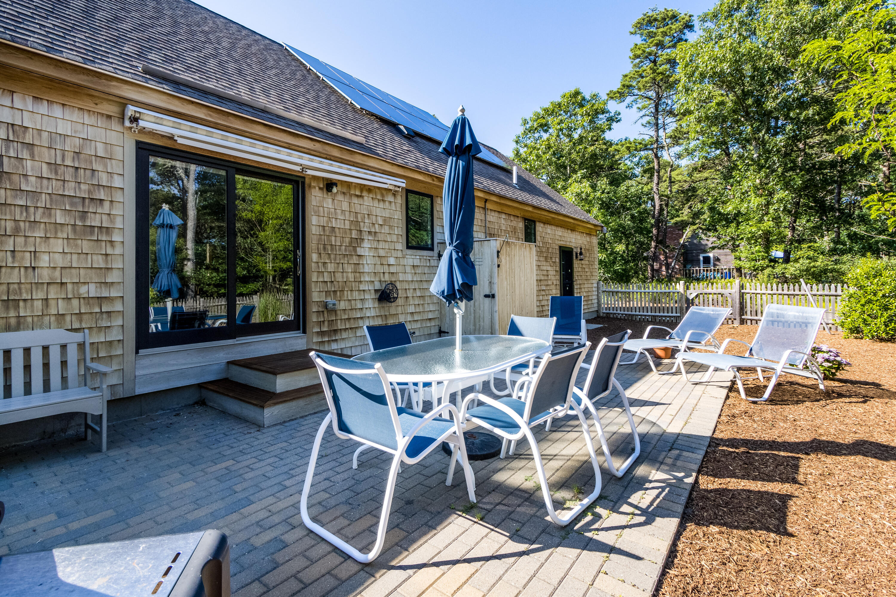 40 Pine Needle Road Wellfleet, MA 02667 - Photo 9 of 36 a view of a patio with table and chairs and potted plants