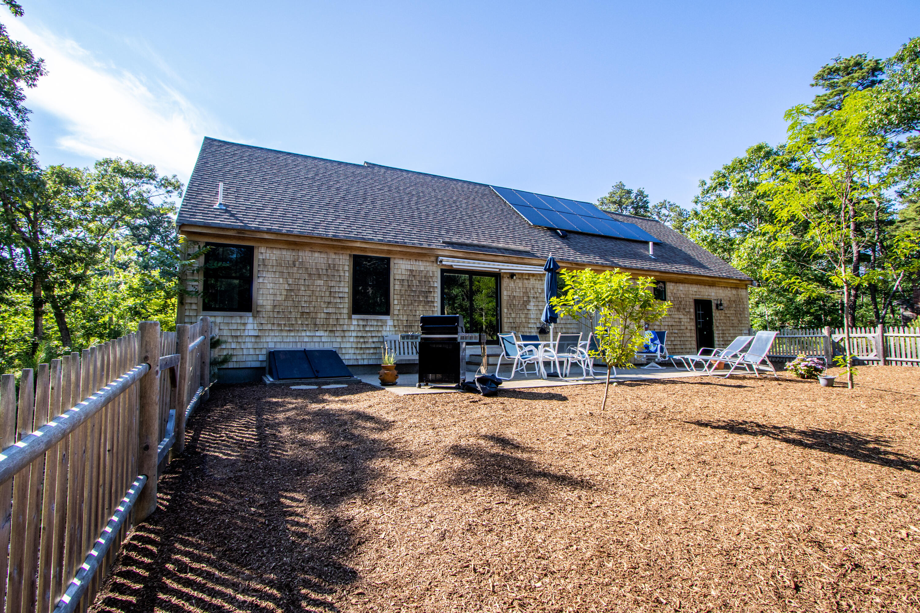 40 Pine Needle Road Wellfleet, MA 02667 - Photo 10 of 36 a view of a house with backyard and sitting area