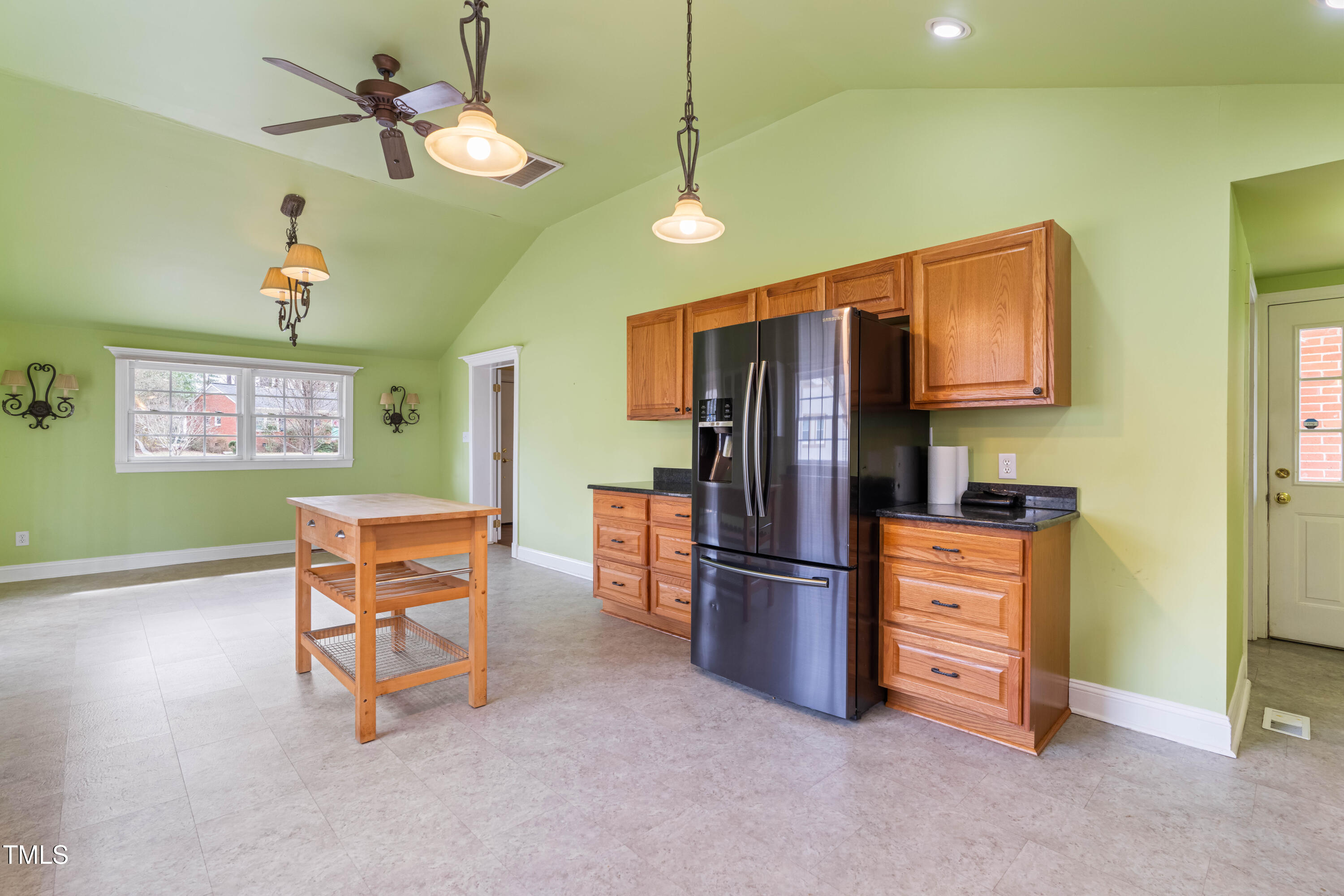 3617 Cranston Road Garner, NC 27529 - Photo 11 of 25 a kitchen with stainless steel appliances granite countertop a refrigerator a stove a sink a dining table and chairs with wooden floor
