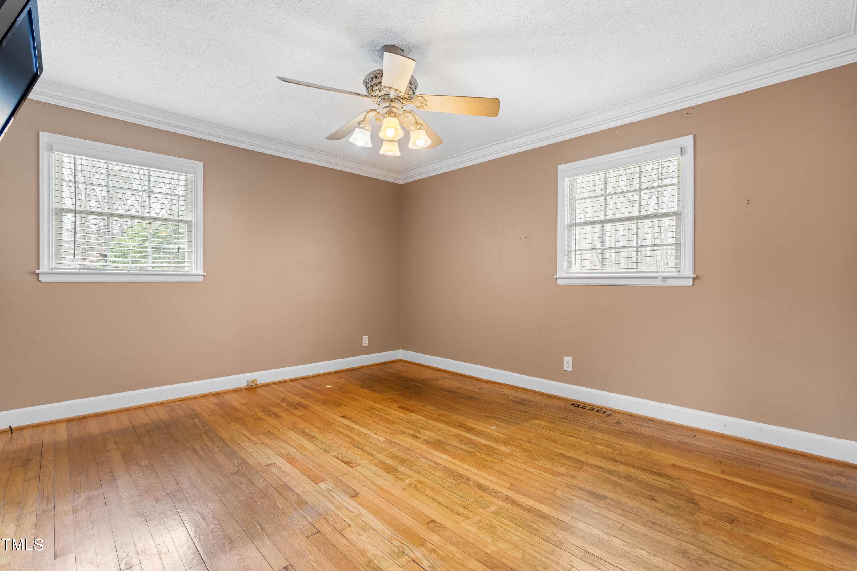 3617 Cranston Road Garner, NC 27529 - Photo 15 of 25 a view of an empty room with wooden floor and a window