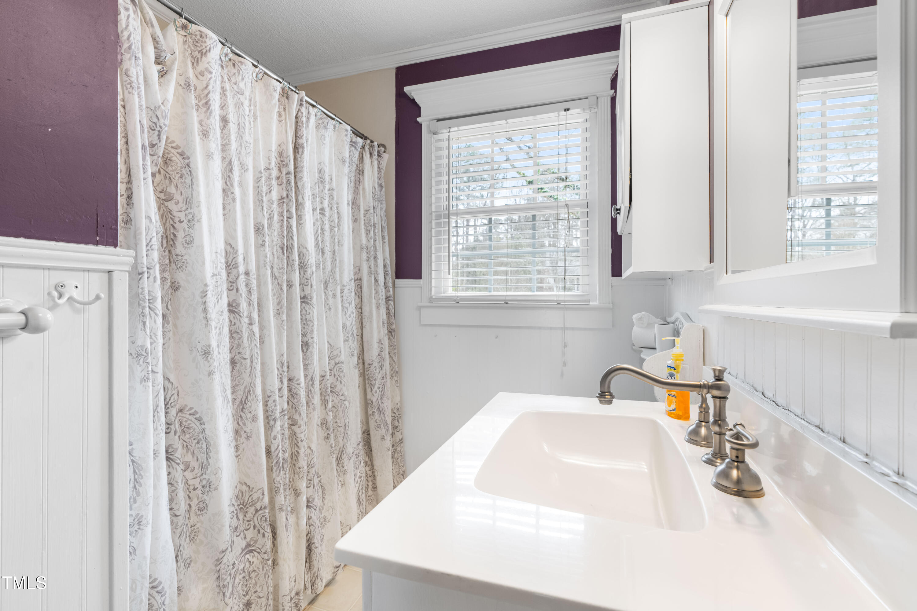 3617 Cranston Road Garner, NC 27529 - Photo 17 of 25 a bathroom with a sink a mirror and a window