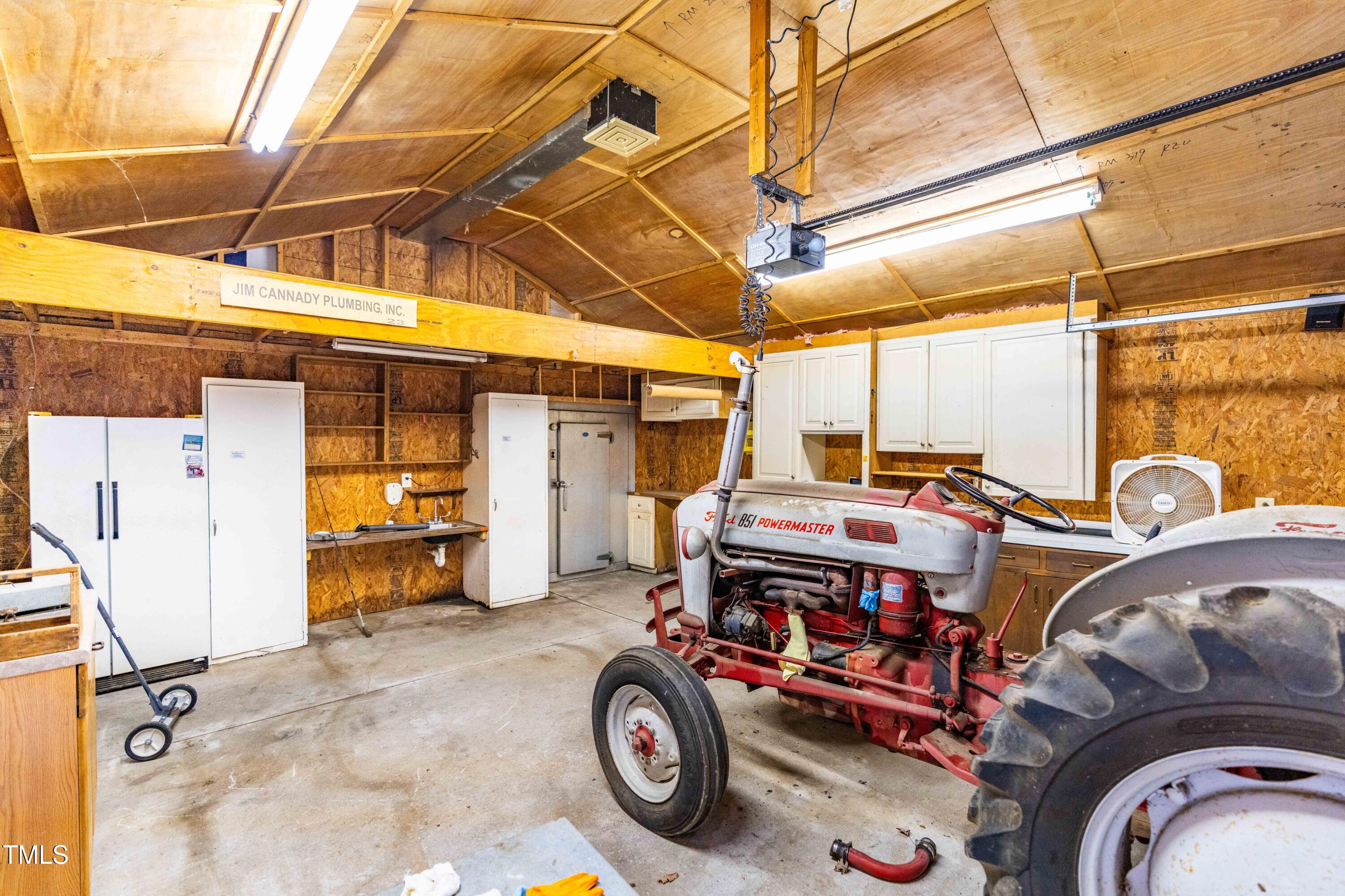3617 Cranston Road Garner, NC 27529 - Photo 20 of 25 a car and bike parked in a garage