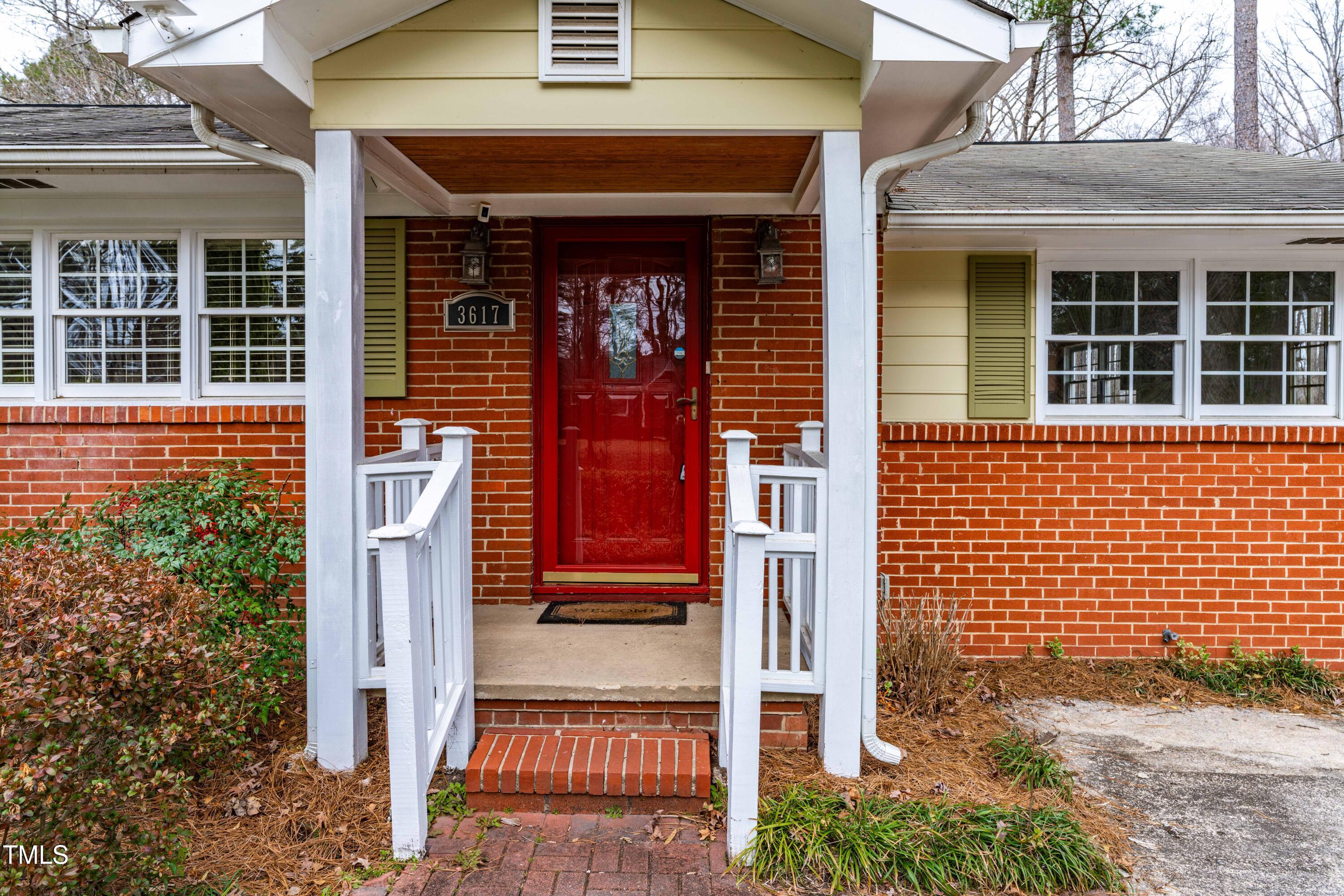 3617 Cranston Road Garner, NC 27529 - Photo 4 of 25 front view of a brick house with a large windows
