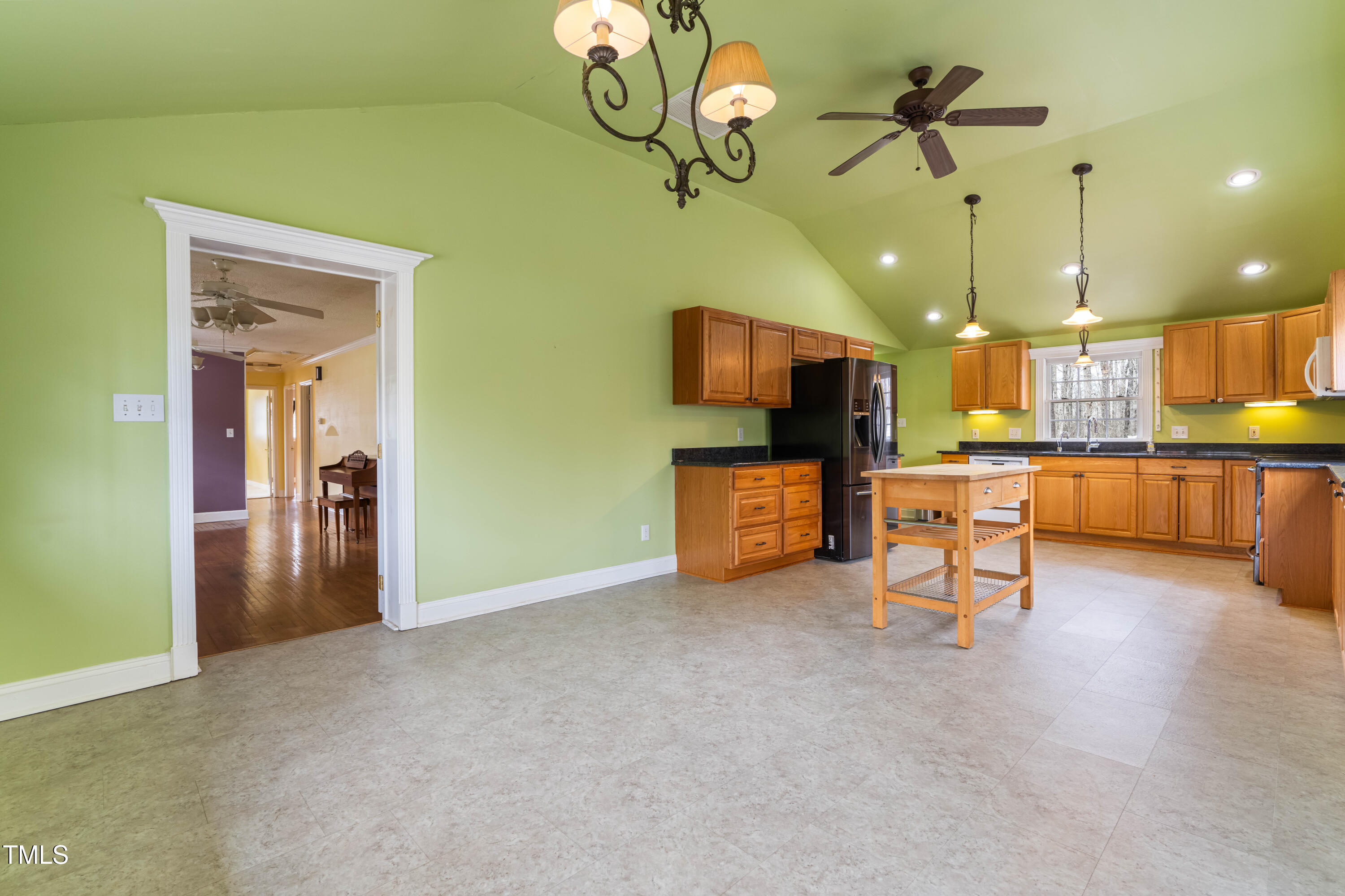 3617 Cranston Road Garner, NC 27529 - Photo 8 of 25 a view of a livingroom with furniture a flat screen tv and kitchen view