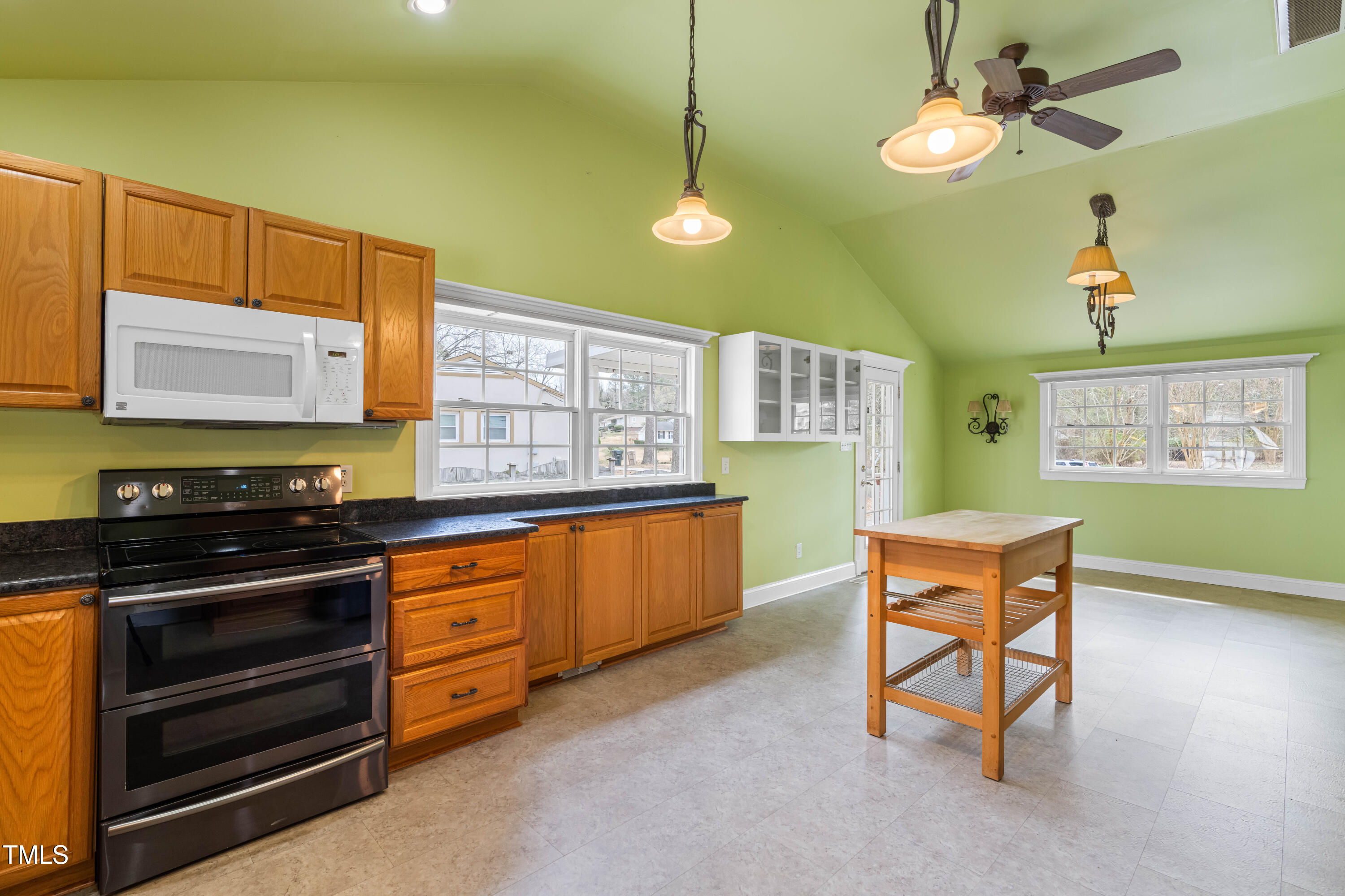 3617 Cranston Road Garner, NC 27529 - Photo 10 of 25 a kitchen with stainless steel appliances granite countertop a stove a sink and a microwave