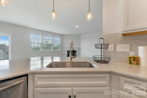 a kitchen with sink and a window